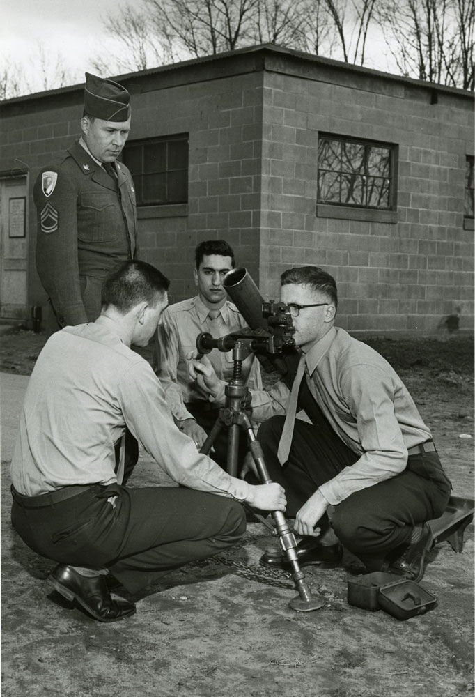 photo of four students training with a M1 81-mm mortar