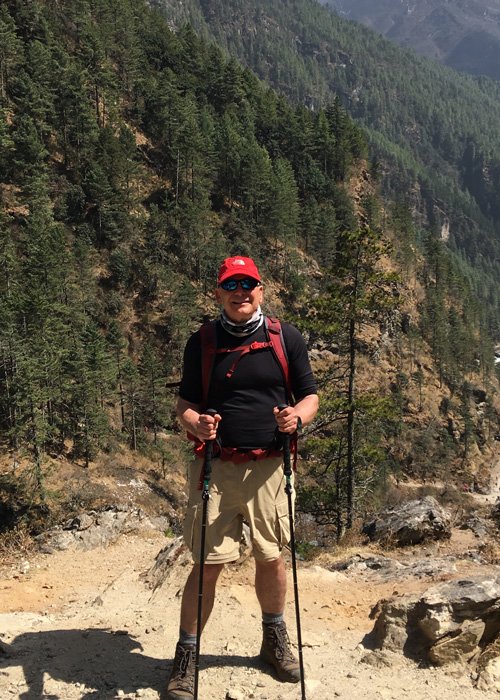 photo of Russ St. John ’80 (ENG), ’85 MBA takes a break while hiking in Nepal