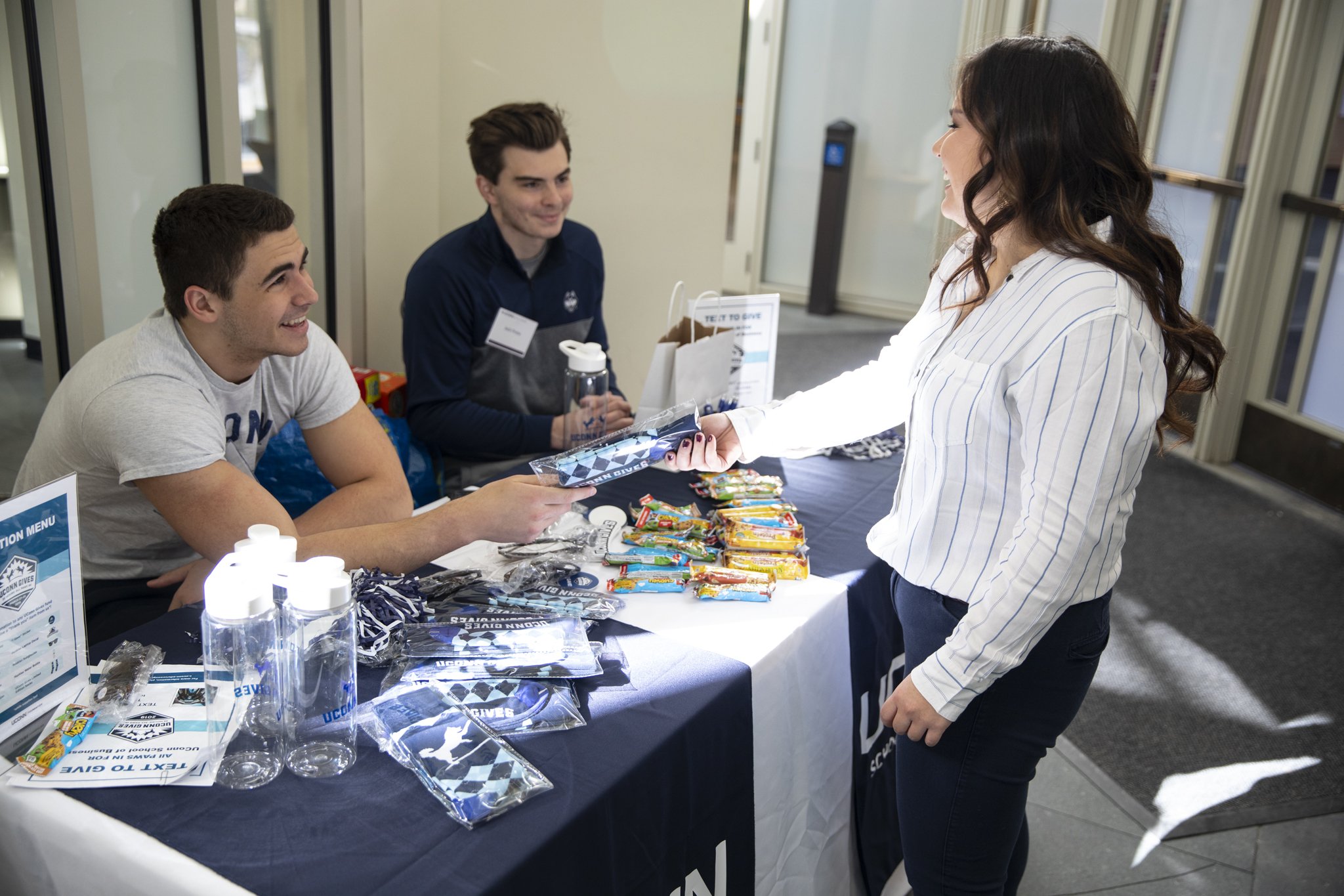 Students at giving table on campus